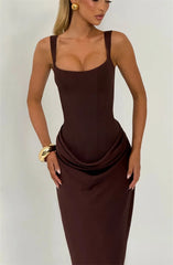 Woman wearing a brown evening gown against a plain background
