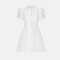 White dress with short sleeves on a light gray background