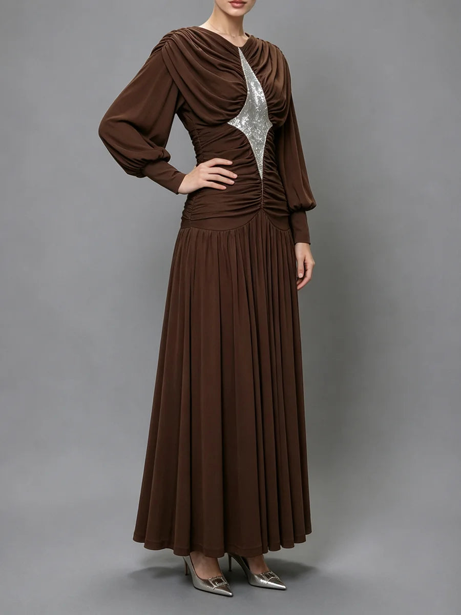 Side view of a sequined draped maxi dress.