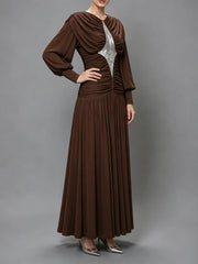 Side view of a sequined draped maxi dress.