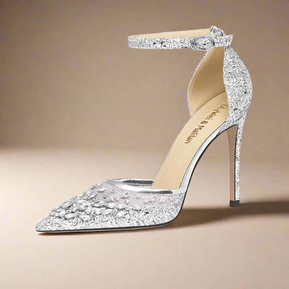 Silver high-heeled shoe with sparkling design on a beige background