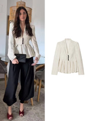 Striped peplum blazer jacket styled with black pants.