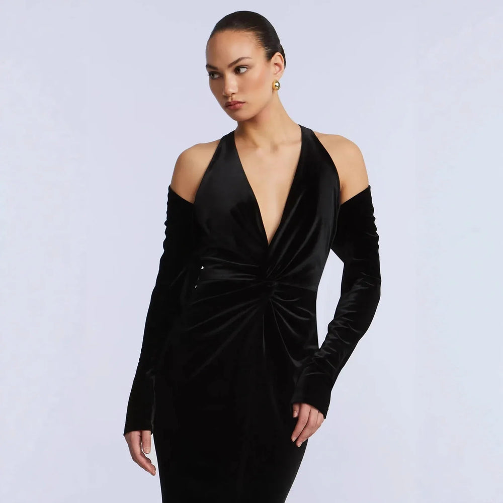 Close-up of black velvet off-shoulder deep v-neck fishtail evening dress neckline