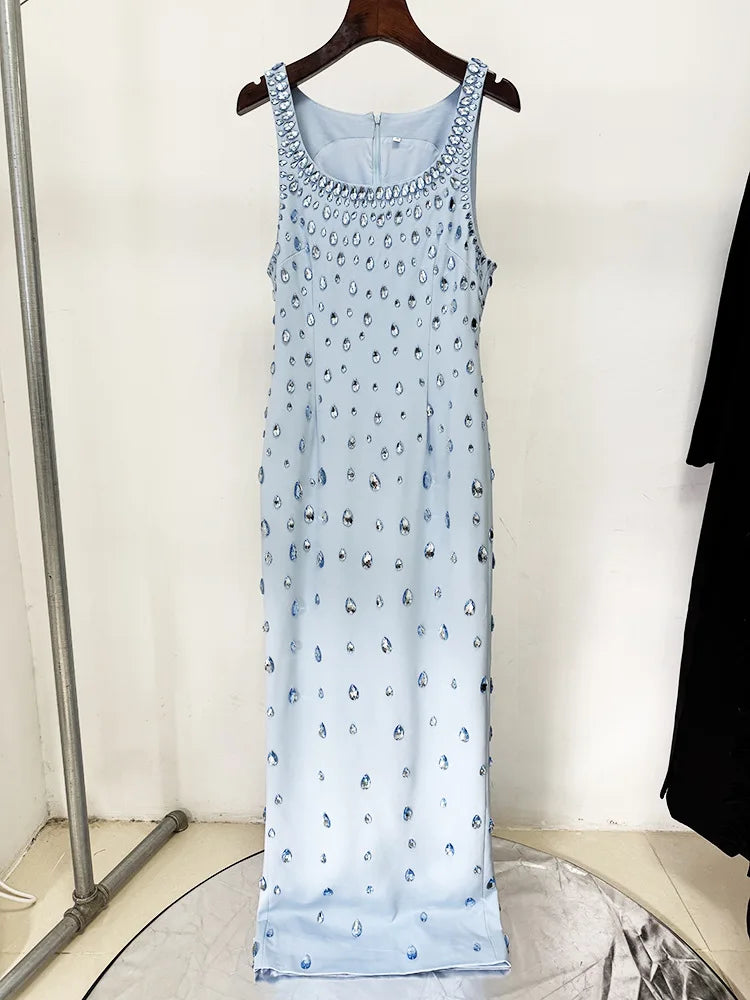 Light blue sleeveless dress with a pattern on a hanger against a white wall.