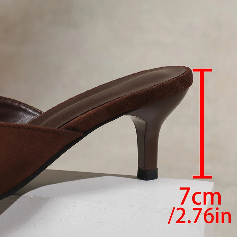 Brown high-heeled shoe with a measurement label indicating heel height on a neutral background