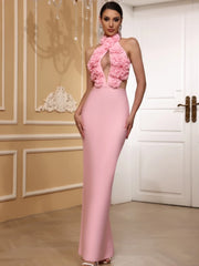 Woman wearing a pink dress with floral details in an elegant room.