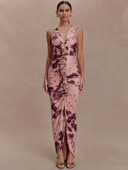 Woman wearing a pink and purple tie-dye dress against a beige background