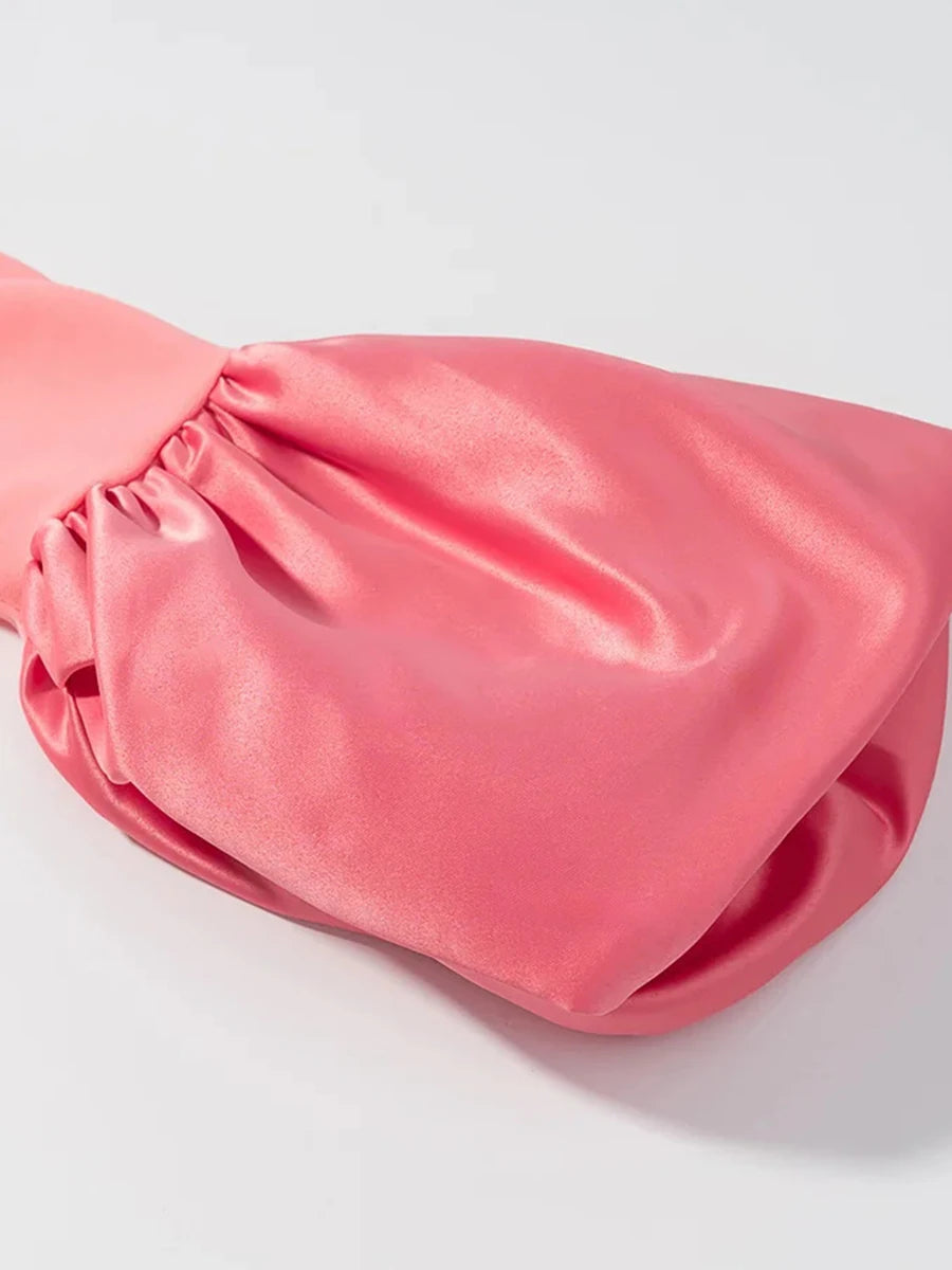 Pink satin bag on a light gray background