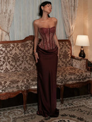 Burgundy sequin strapless corset maxi dress on a model