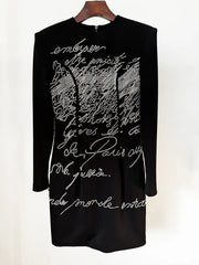 Black beaded script long sleeve mini dress on hanger