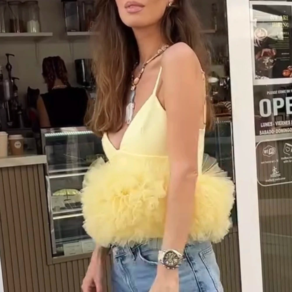 Woman wearing a yellow fluffy top in a casual setting
