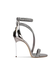 Silver high-heeled sandal with embellishments on a white background