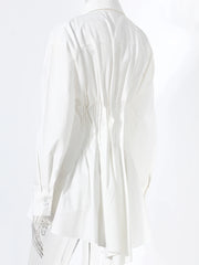 White blouse with ruffled details on a white background