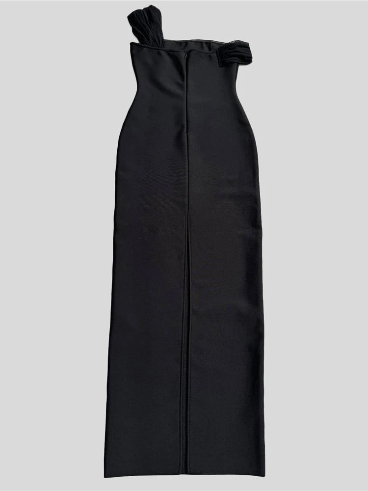 Black one-shoulder dress with a bow detail on a light gray background
