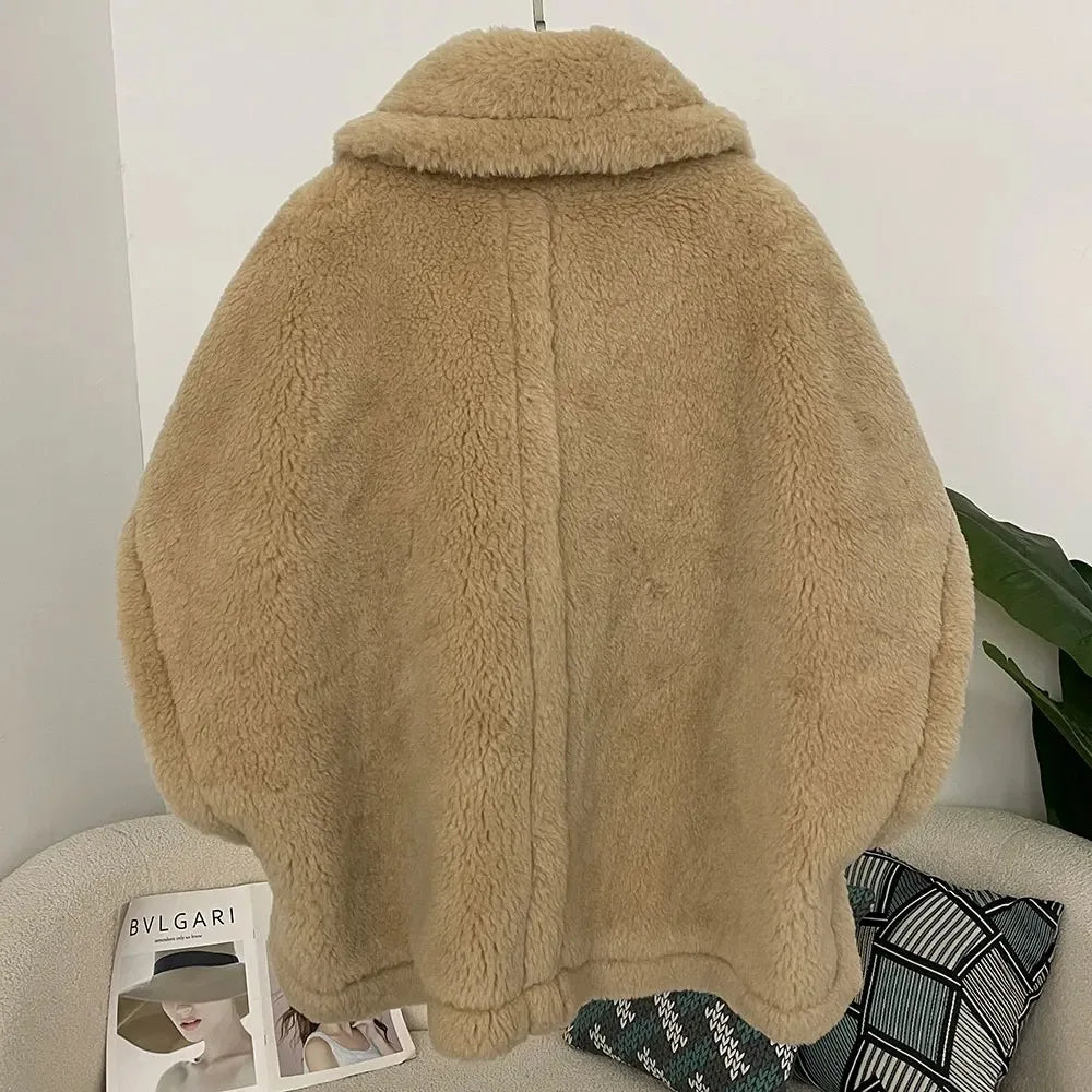 Beige fluffy jacket on a chair with a magazine underneath