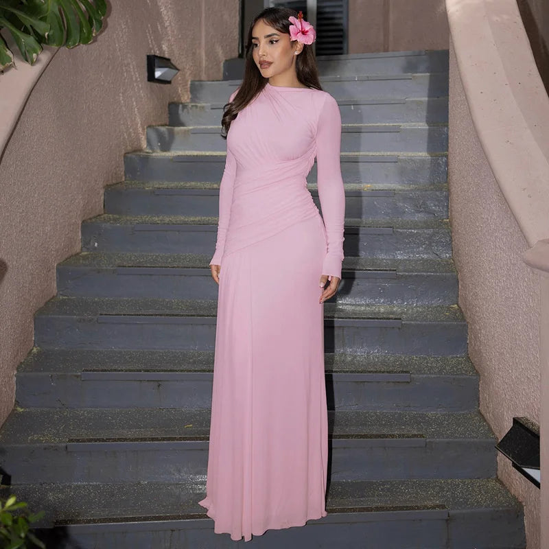 Woman in a pink dress standing on a staircase