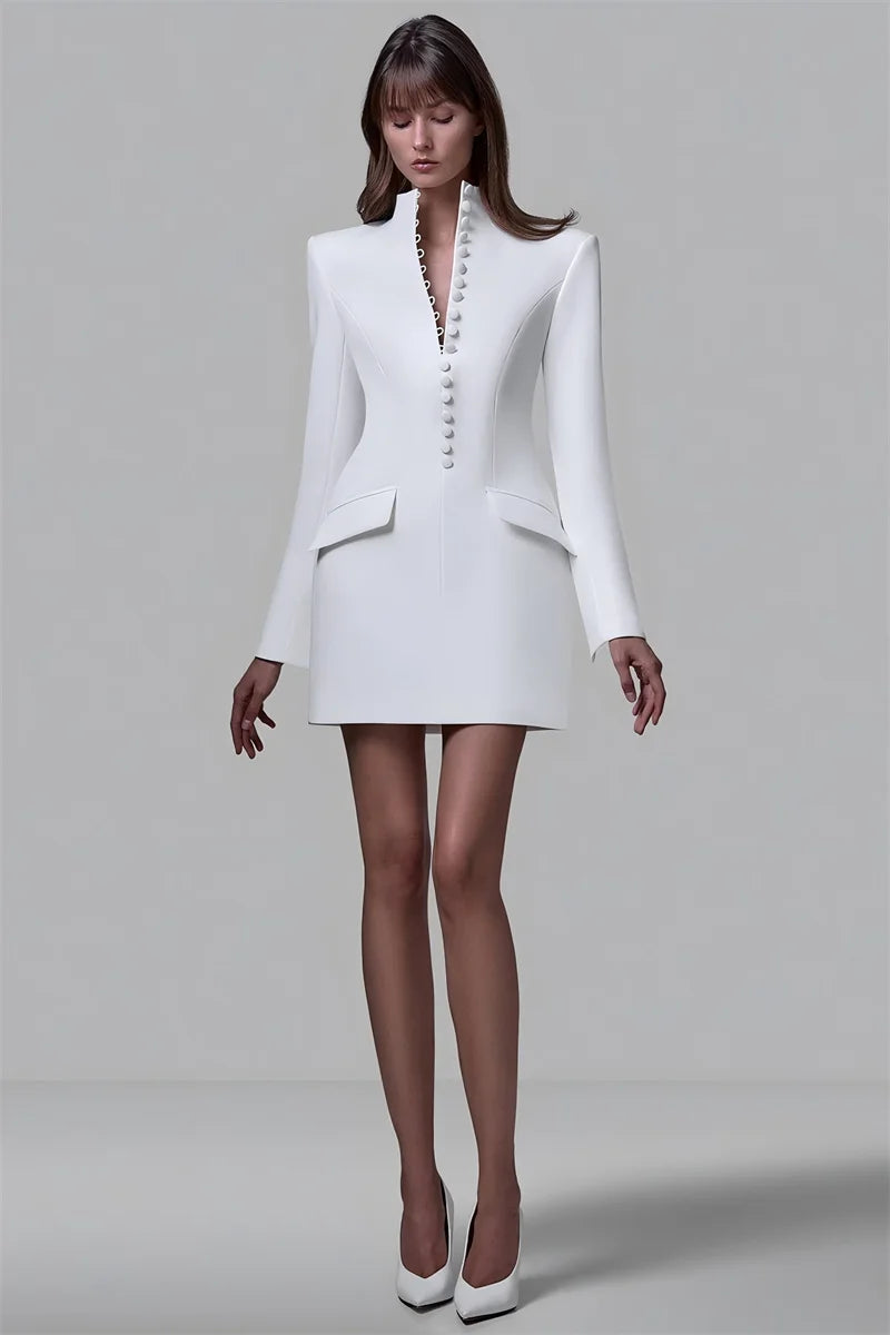 Woman wearing a white blazer and skirt set on a plain background