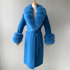 Blue coat with fur trim on a mannequin against a gray background