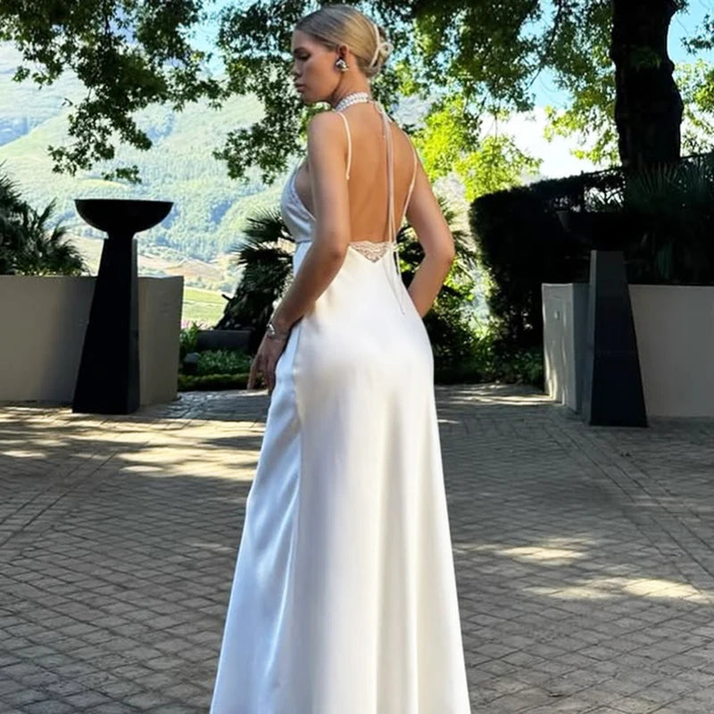 Woman in a white evening gown with a scenic background