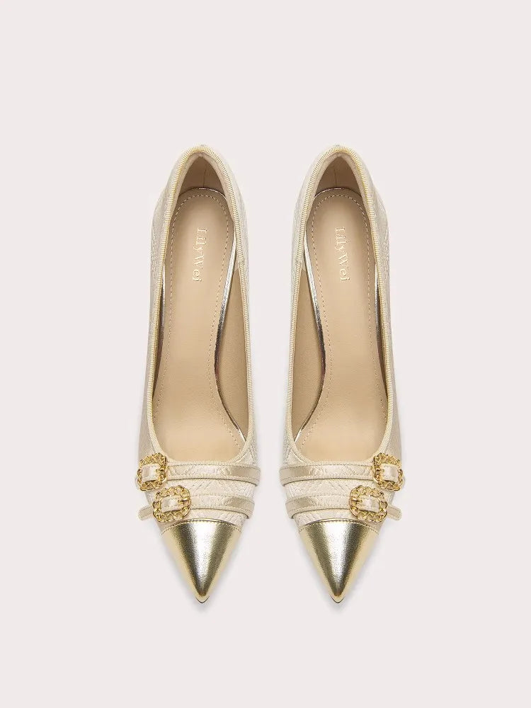 Gold high-heeled shoes with decorative straps on a light beige background