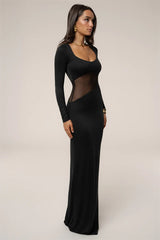 Black evening gown with sheer panels worn by a model on a plain background