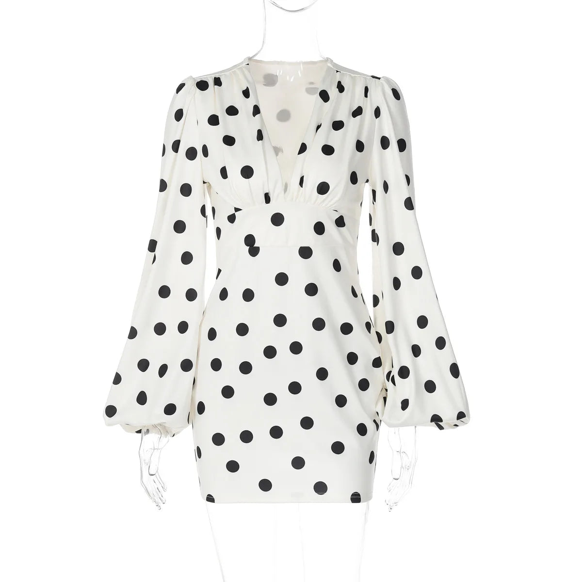 White dress with black polka dot pattern on a white background