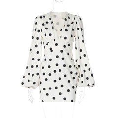 White dress with black polka dot pattern on a white background