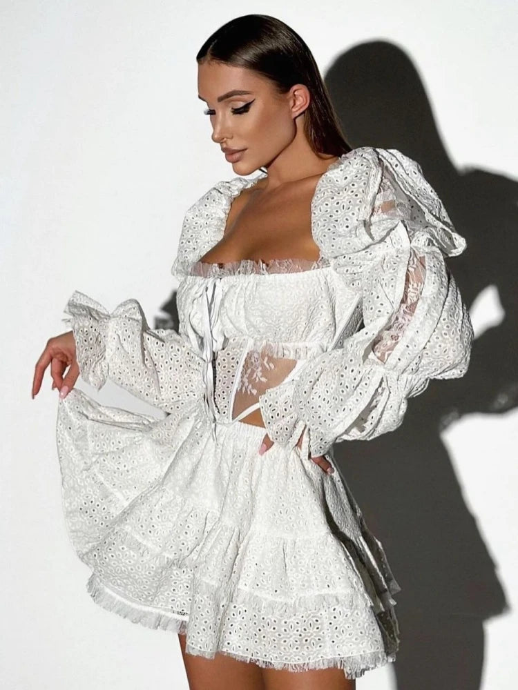 Woman wearing a white lace dress against a white background