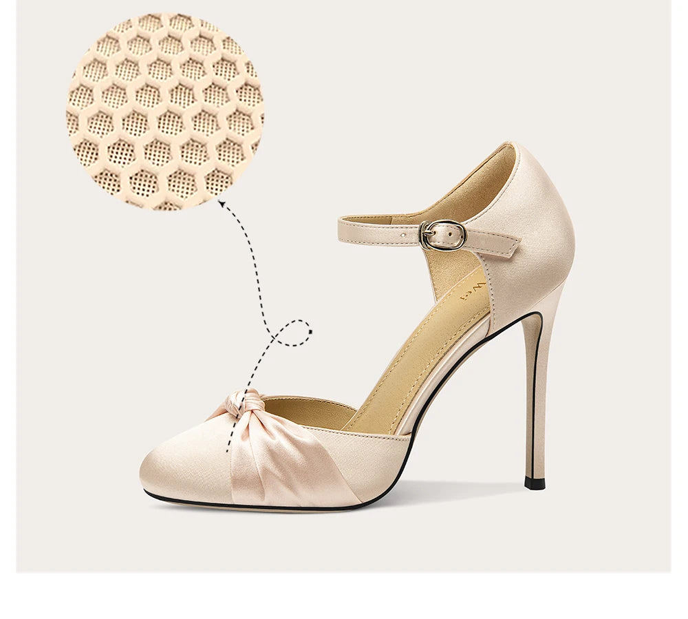 Beige high-heeled shoe with a close-up of the sole on a light background