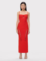 Woman wearing a red dress with cut-out details on a white background