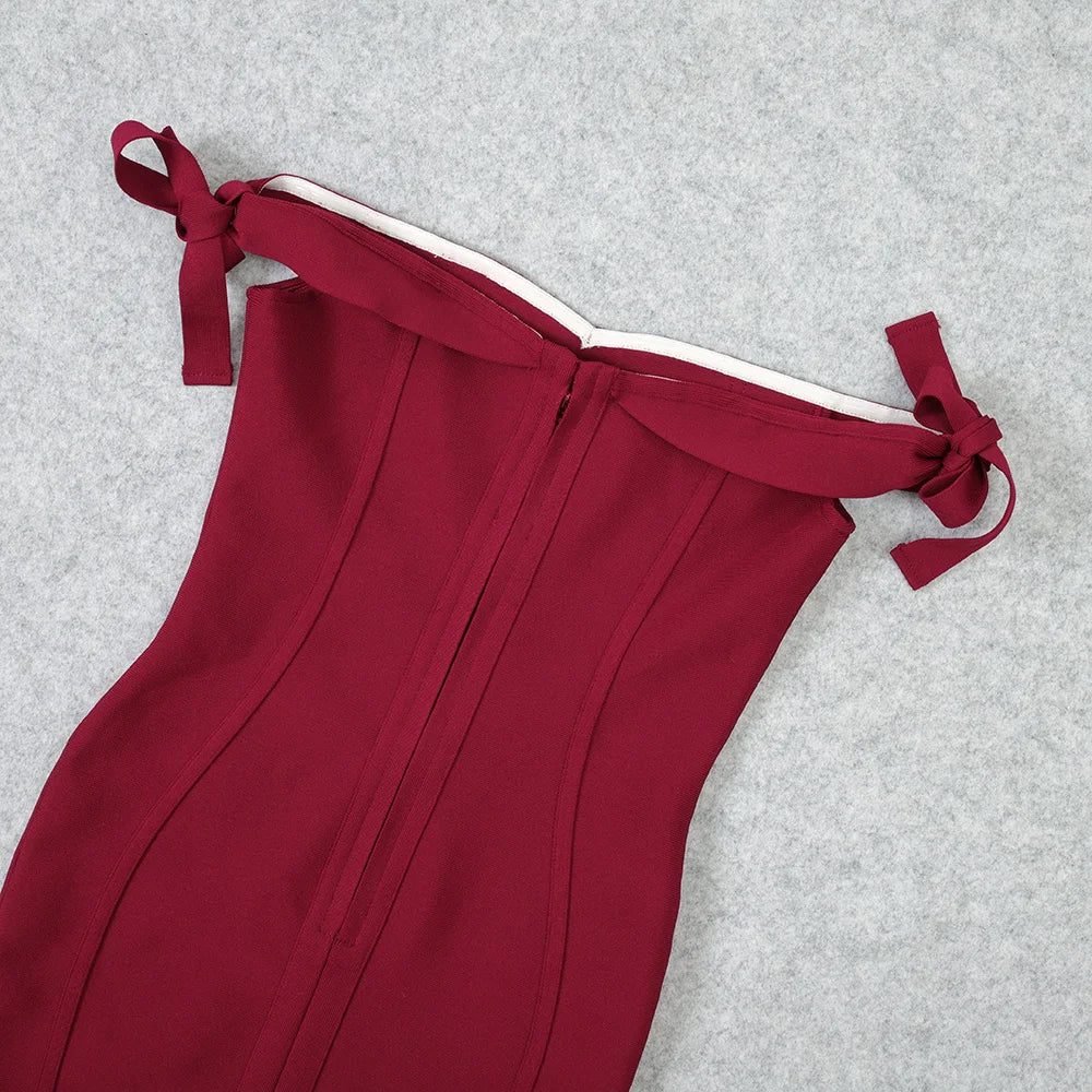 Red off-shoulder dress with tied straps on a gray background