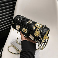 Black quilted embellished barrel bag