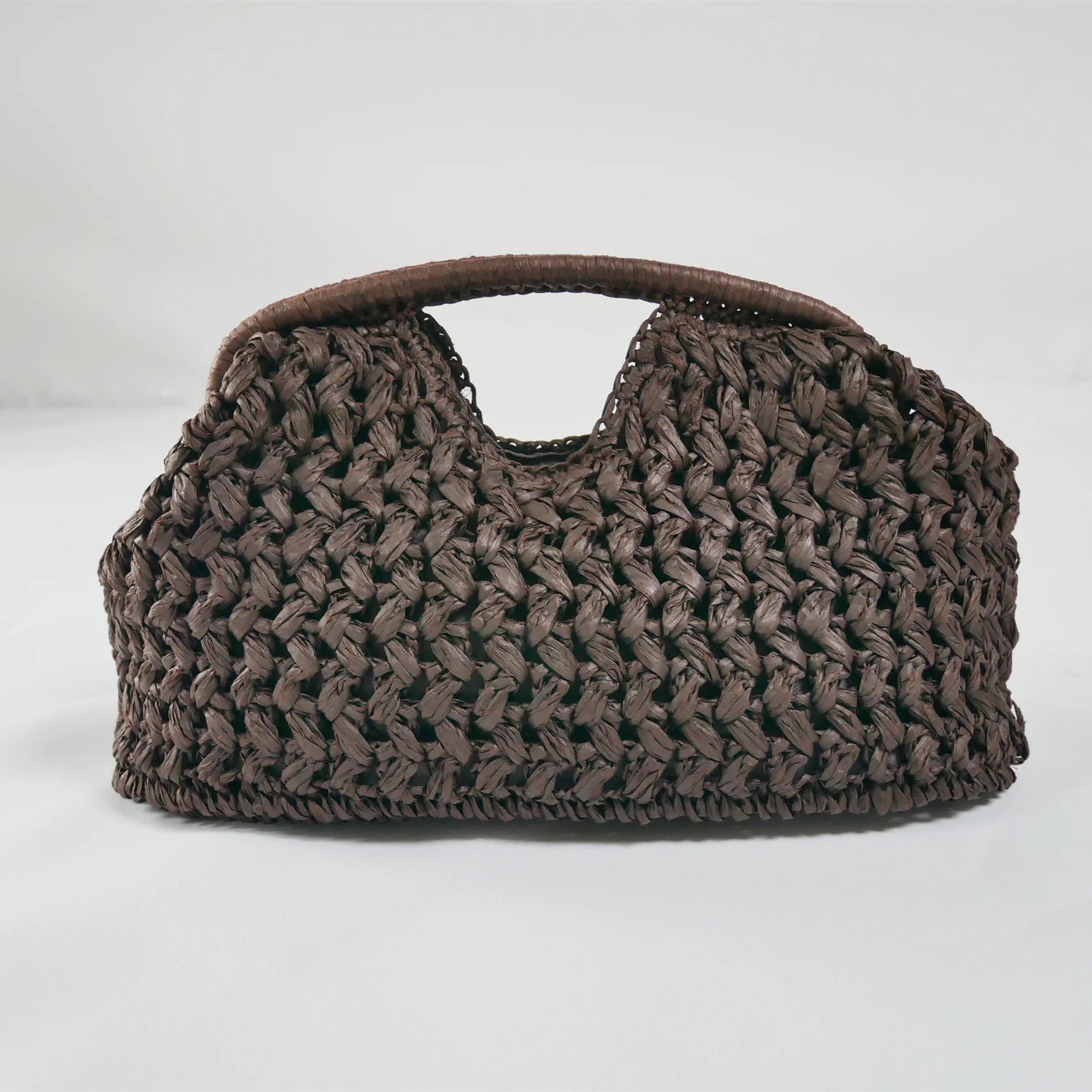 Coffee woven handbag on a white background