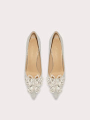 Pair of silver pointed-toe flats with crystal embellishments on a light gray background