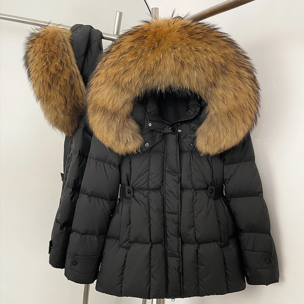 Black puffer jacket with a large fur hood on a rack