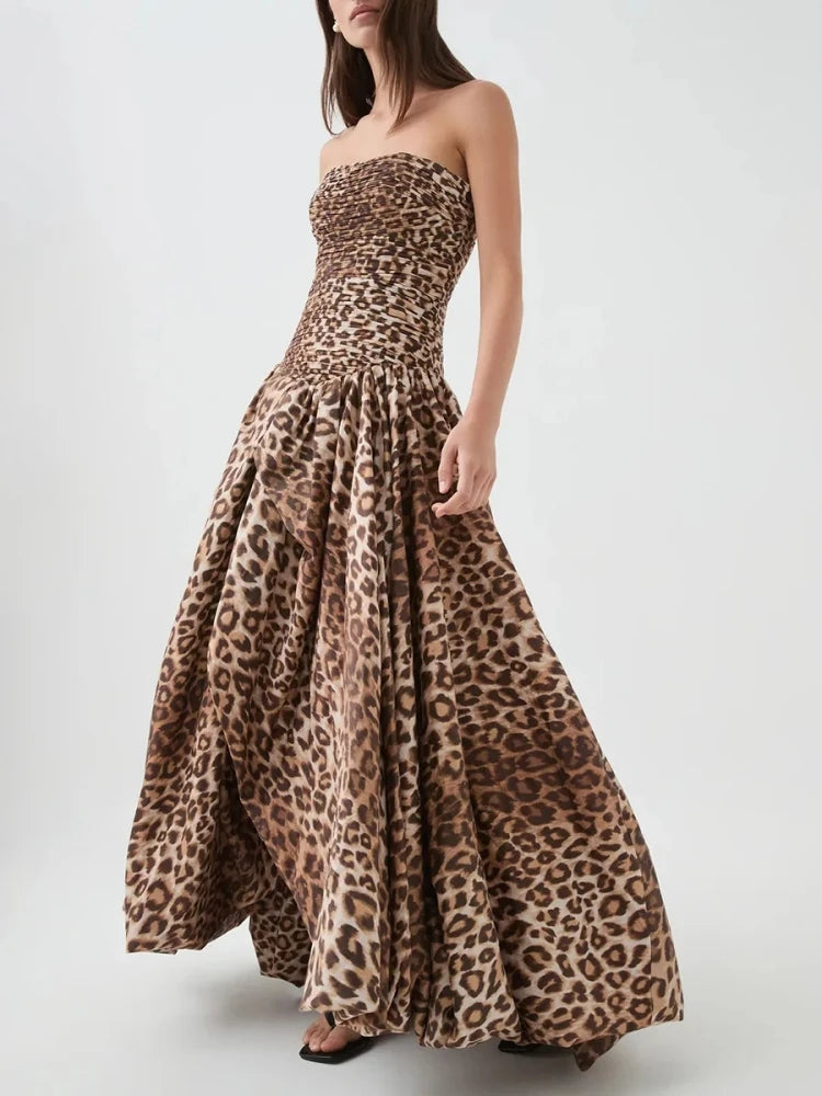 Woman wearing a strapless leopard print dress on a white background