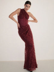 Woman wearing a burgundy evening gown against a white background