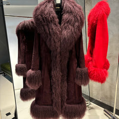 Brown fur coat with matching gloves and red fur coat in a store setting