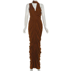 Brown draped evening gown on a mannequin against a white background