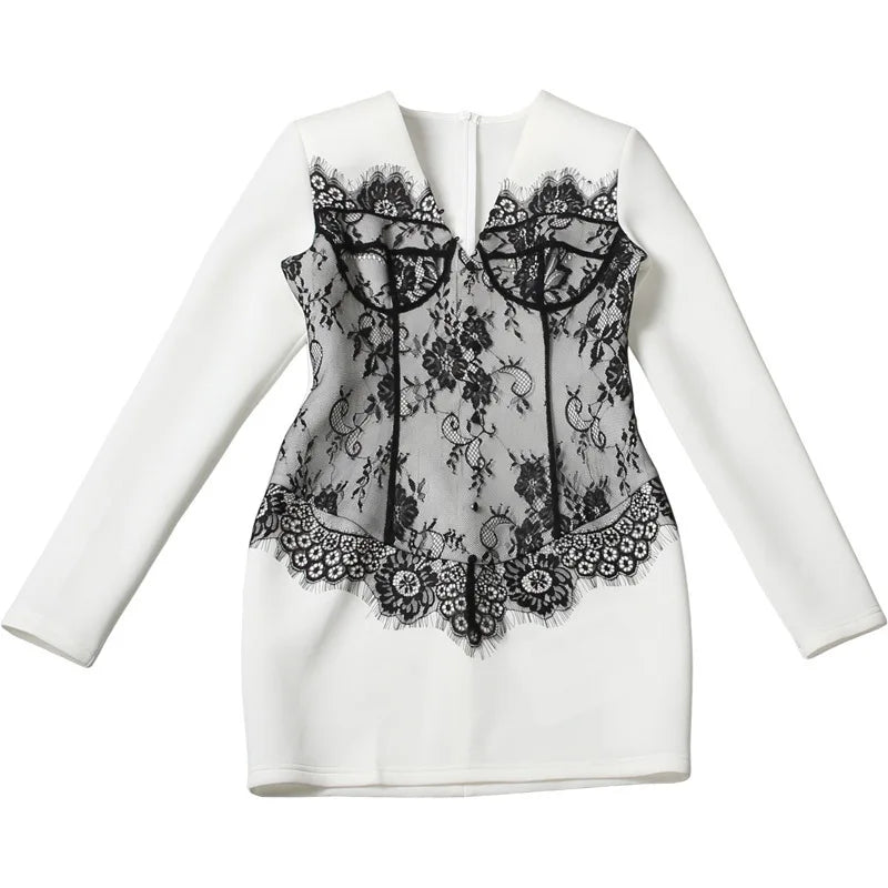 White jacket with black lace detailing on a white background