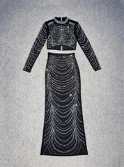 Black dress with silver embellishments on a gray background