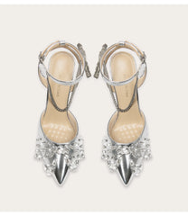 Silver high-heeled shoes with crystal embellishments on a white background