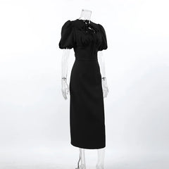 Black dress on a mannequin against a white background