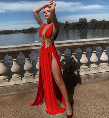 Woman in a red dress standing by a waterfront with a scenic background