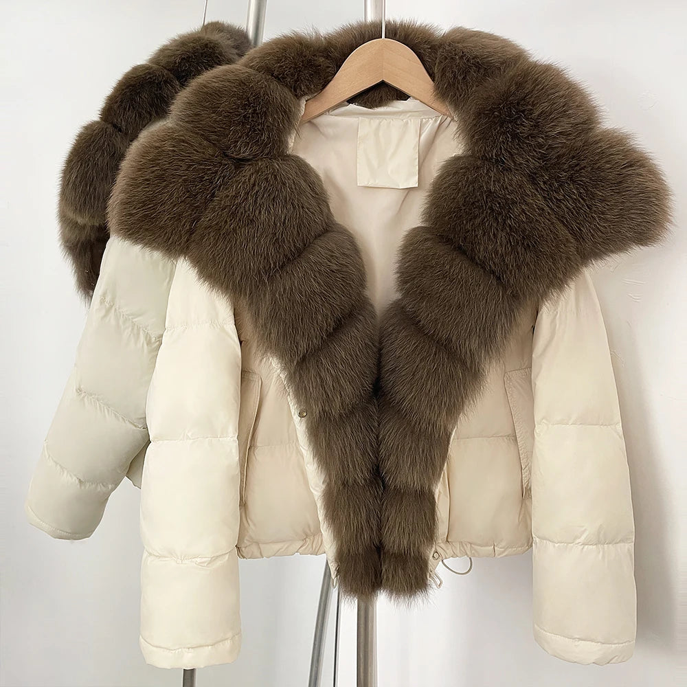 Beige puffer jacket with brown fur collar on a hanger against a white background