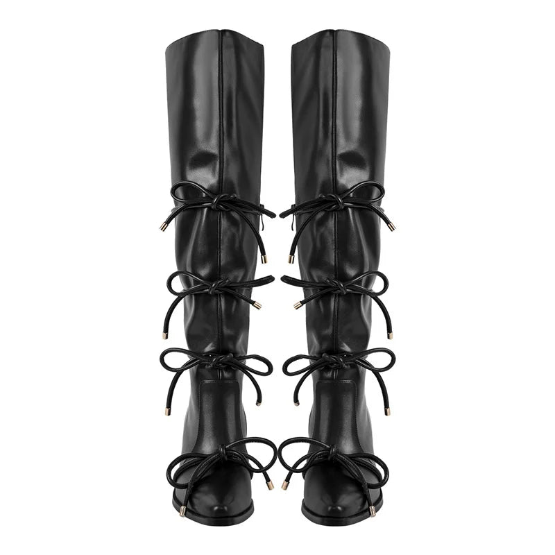 Black pointed toe knee high boots with bow detail and block heel