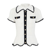 White knit collared short sleeve top with black trim and gold buttons