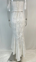 White lace dress on a mannequin against a plain background