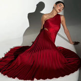 Red asymmetrical one-shoulder gown with cascading pleats.