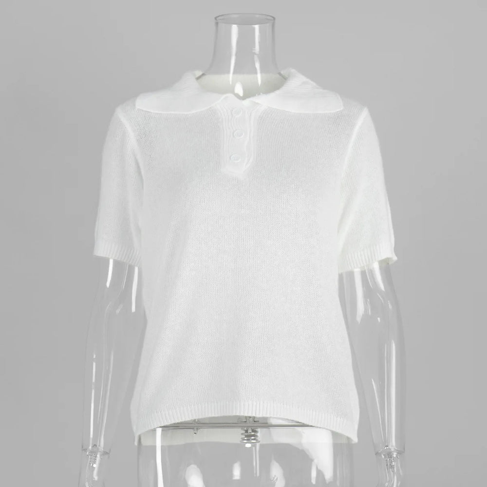 White top on a mannequin against a gray background